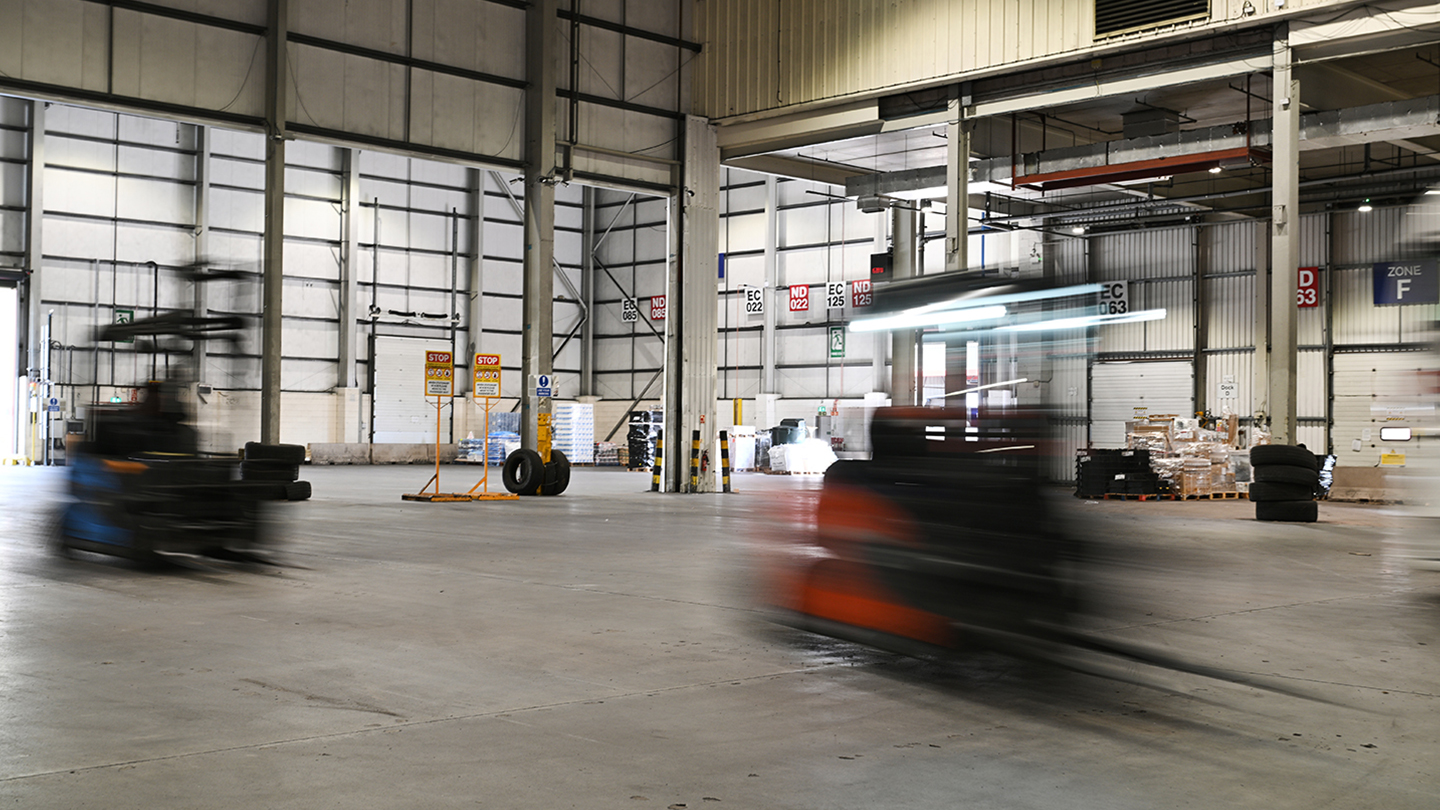 Image of a warehouse with blurred vehicles