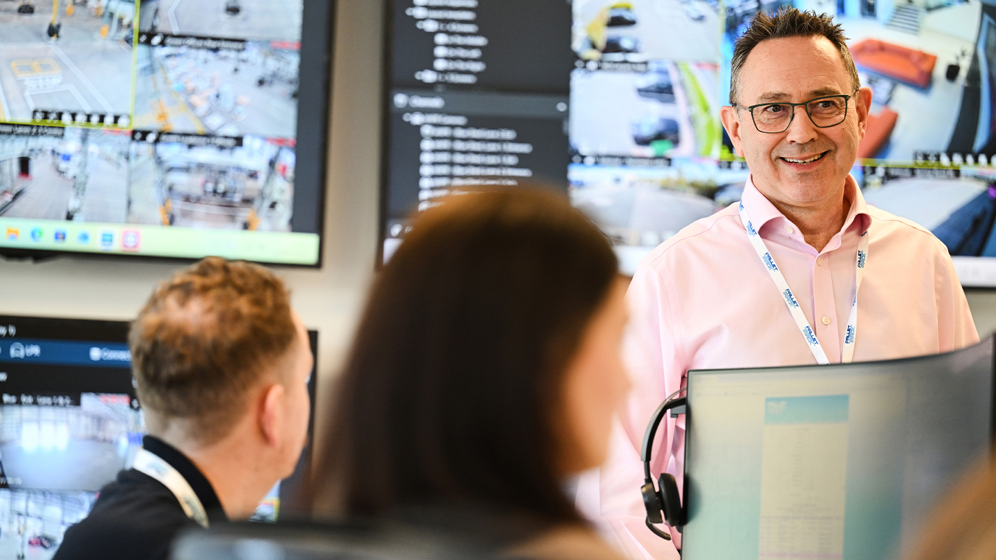 Image of office staff looking over PCs