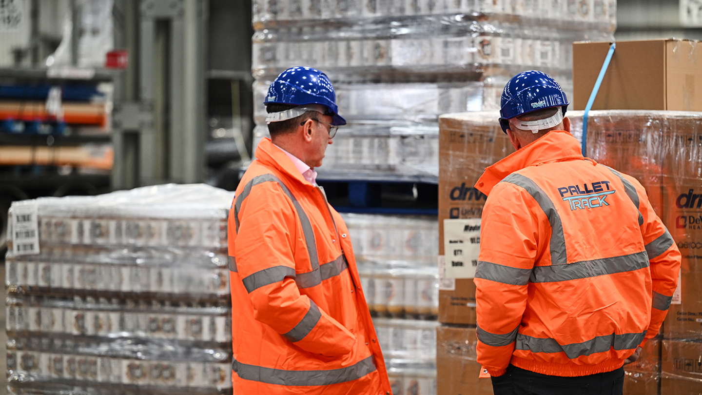 Image of two warehouse workers looking at cargo