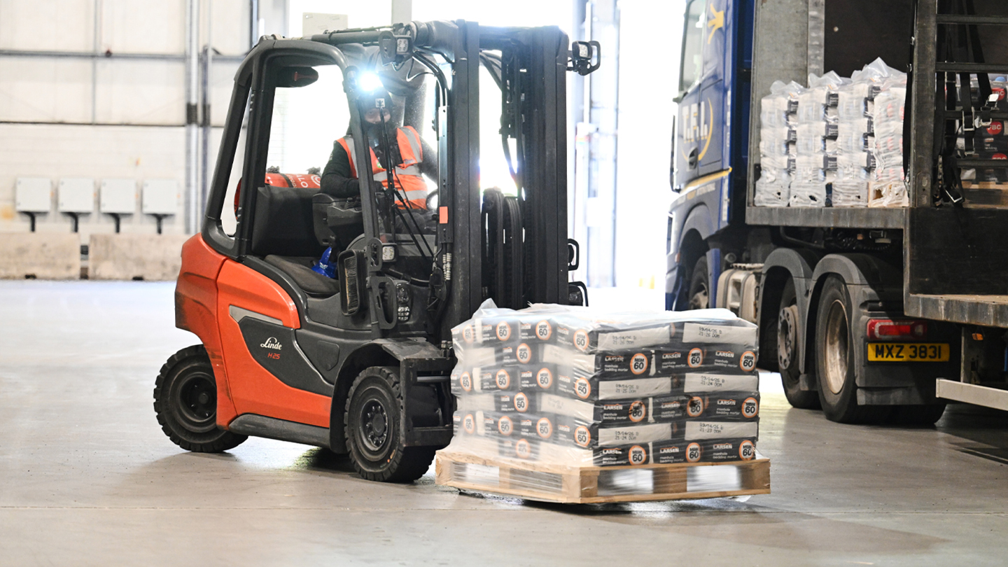 Image of a forklift lifting a heavy load