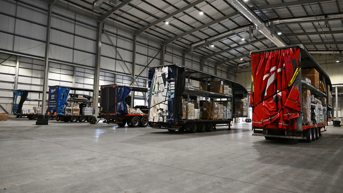 Image of lorries lined up in a warehouse