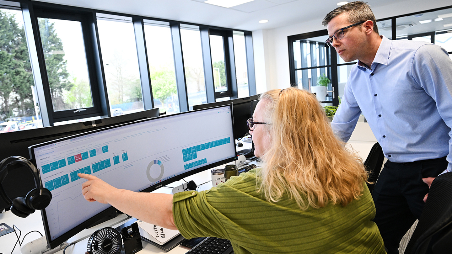 Image showing staff pointing to the screen of a PC